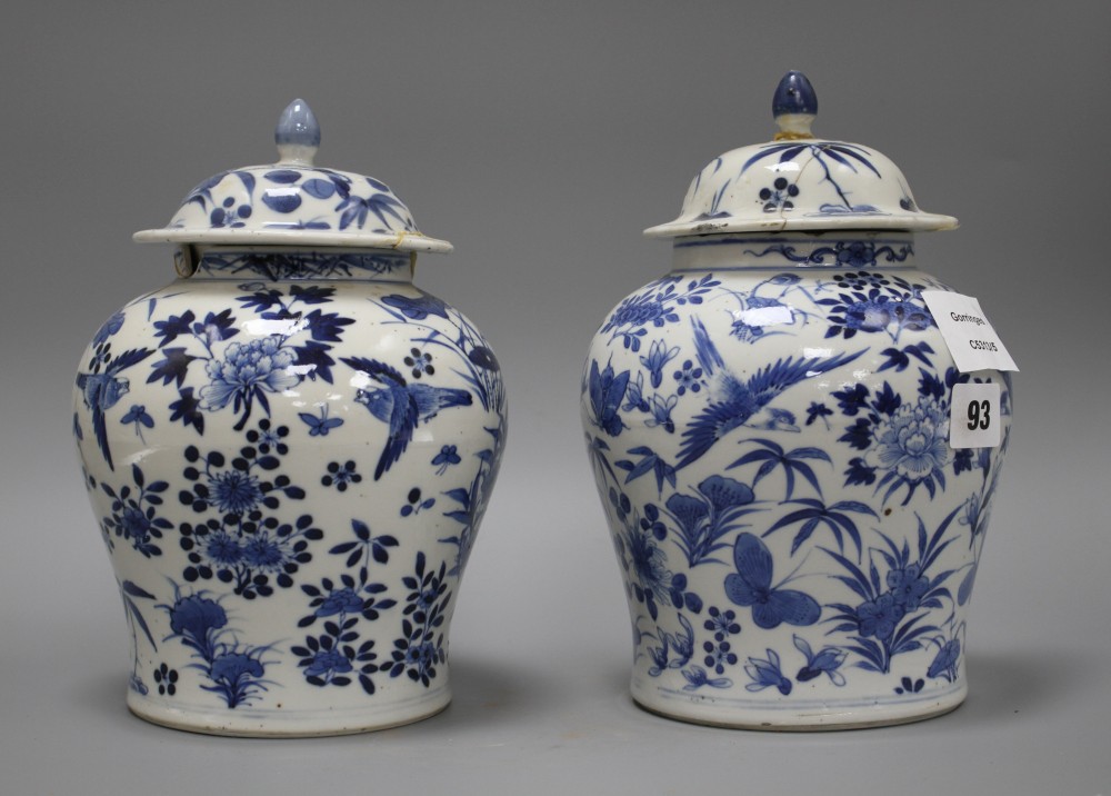 A pair of 19th century Chinese blue and white vases and covers, decorated with birds and flowers, height 23cm